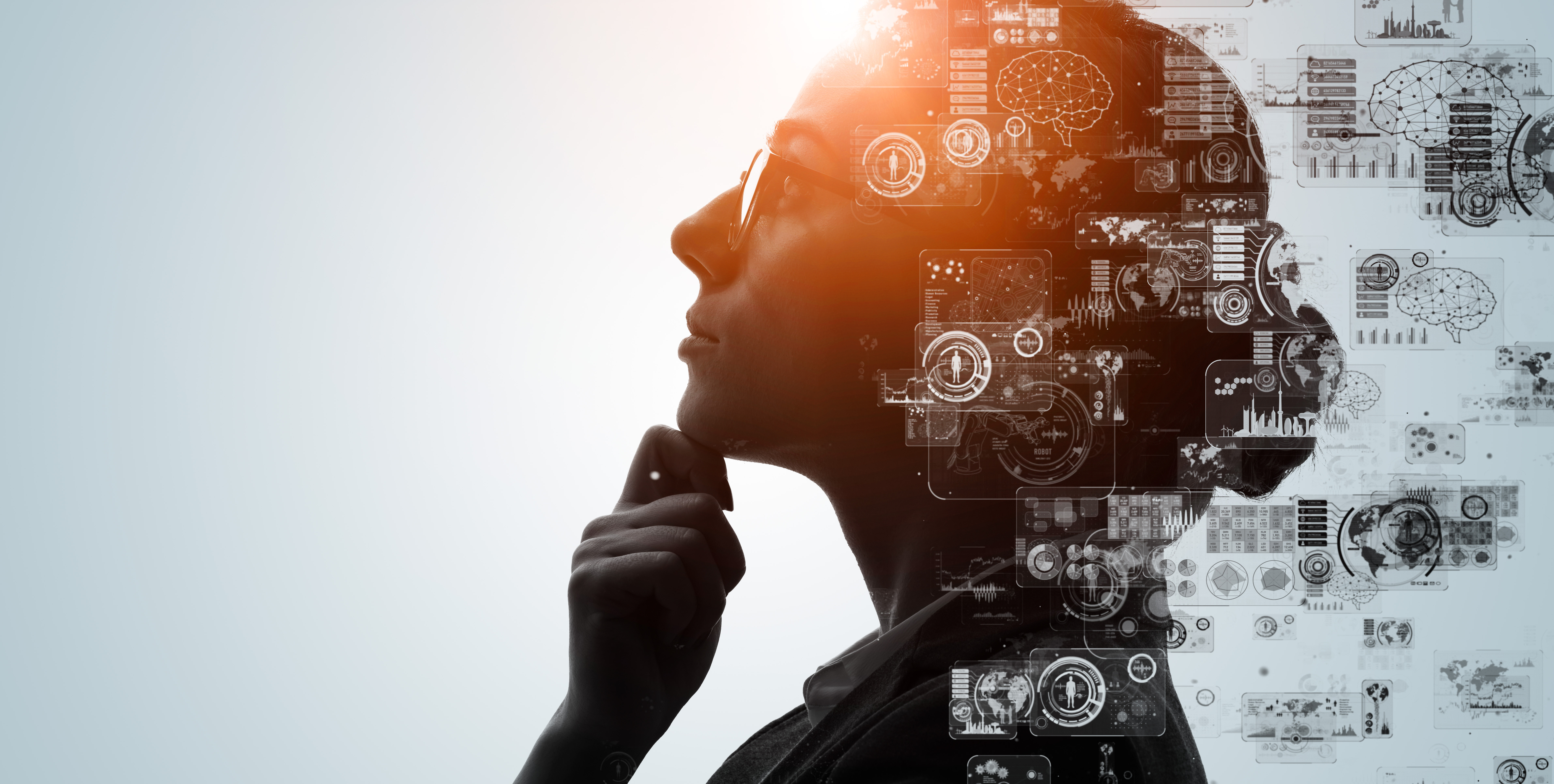 Silhouetted thinker overlaid with data and chart imagery